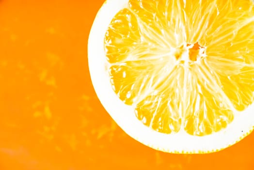 Slice of orange in the orange background