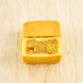 The tasty Taiwanese pineapple pastry cake with egg yolk on the wooden plank.