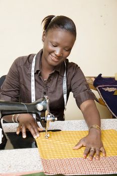 This young woman is very cheerful this morning at her sewing machine which gives her that beautiful smile