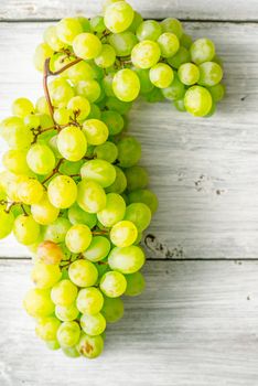 Grapes on the white wooden table vertical