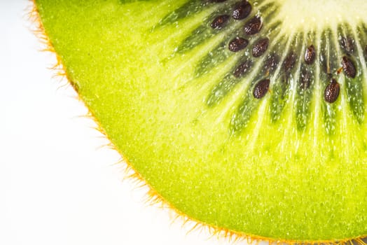 Slice of kiwi on the white background close-up