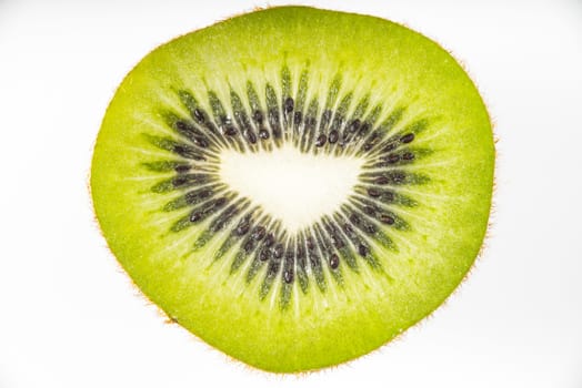 Slice of kiwi on the white background top view