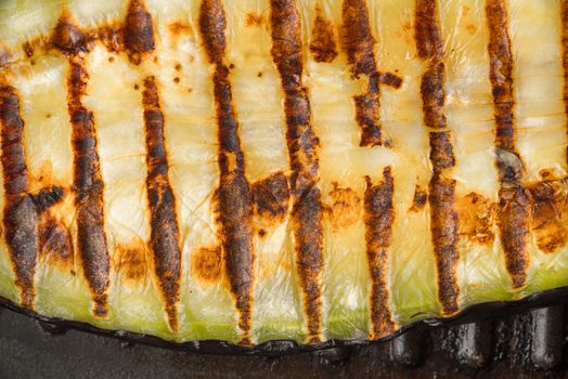 Grilled eggplant slice on the metal background close-up