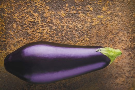 Eggplant on the brown stone background top view
