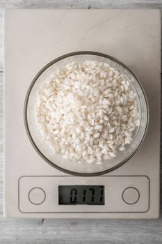 Rice in the glass bowl on the scale vertical