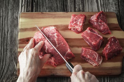 Cutting angus beef on the wooden table horizontal