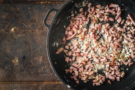 Frying bacon in the pan top view