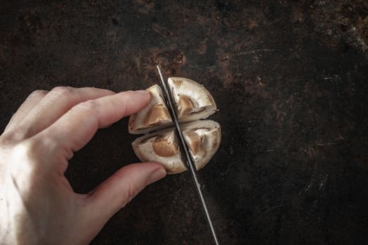 Cutting mushroom on the old metal background top view