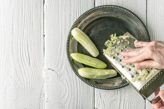 Grate cucumbers in the metal plate top view