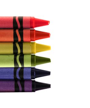 six used colored vax crayons form rainbow