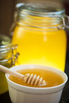 Honey with walnut on wooden background