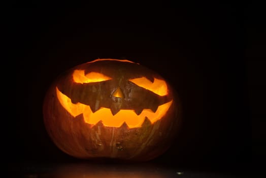 Halloween pumpkin with scary face on black backgound