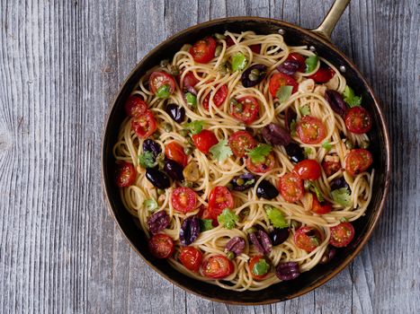 close up of rustic italian spaghetti puttanesca pasta