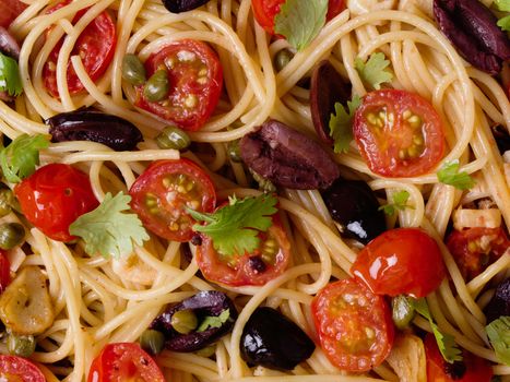 close up of italian spaghetti puttanesca pasta food background