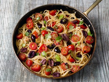 close up of rustic italian spaghetti puttanesca pasta