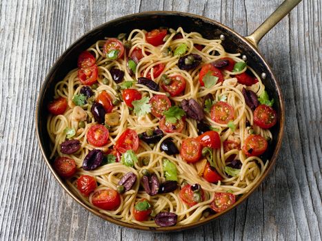 close up of rustic italian spaghetti puttanesca pasta