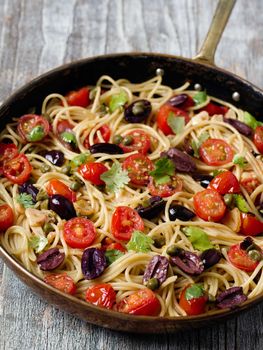 close up of rustic italian spaghetti puttanesca pasta