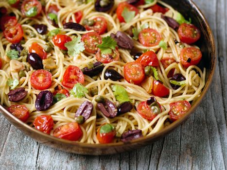 close up of rustic italian spaghetti puttanesca pasta