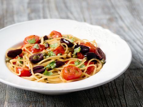 close up of rustic italian spaghetti puttanesca pasta