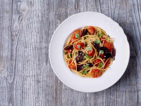 close up of rustic italian spaghetti puttanesca pasta