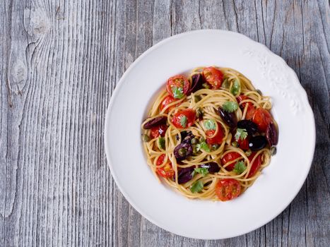 close up of rustic italian spaghetti puttanesca pasta