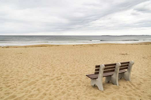 Bench on ocean beach in Maine, USA