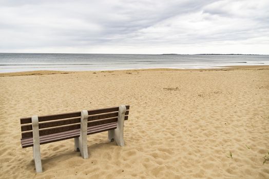 Bench on ocean beach in Maine, USA