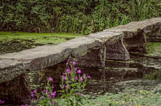 Stone bridge in pond at Nostell Priory England