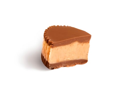 Piece of chocolate cake with icing on white isolated background