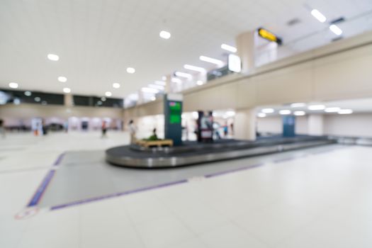 Blurred, bokeh background of baggage claim belt area in arrival zone of an airport