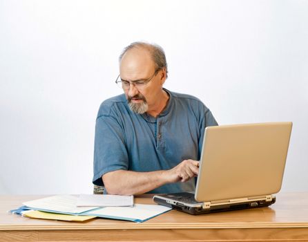 A businessman transcribes his notes onto the computer.
