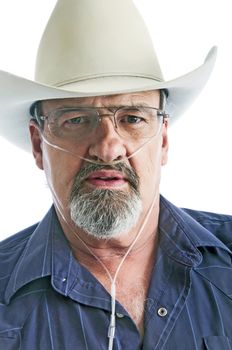 Mature cowboy with a breathing disability, wearing an Oxygen cannula and eyeglasses.