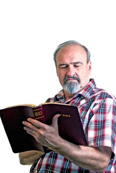 A man with strong convictions studies a bible
