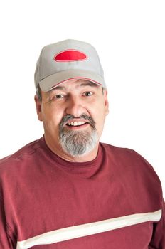 Good natured smile from a sixty five year old man wearing a baseball cap. isolated on a white background.