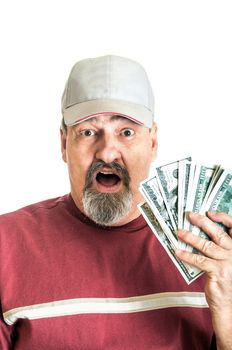 Adult male with a shocked look on his face with hand full of American one hundred dollar bills.