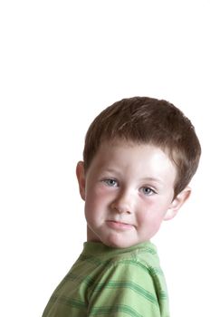 Baby boy looking toward the camera with a challenging look. Isolated on white