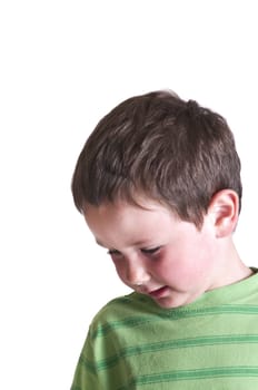 Little boy with his attention towards the floor isolated on white.