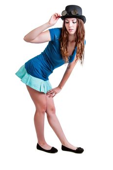 Pretty young girl in a short skirt wearing a steam-punk hat with goggles. Isolated against a white background