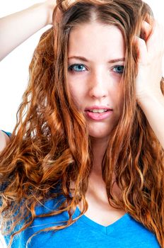 Pretty young woman with auburn hair in a close up portrait.