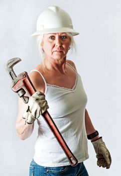 Strong woman worker holding a pipe wrench