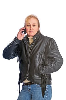 Adult blonde woman wearing a leather jacket talking on her cell phone 