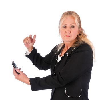 Adult woman angry about a message on her cellphone looking back over her shoulder. Isolated on a white background.
