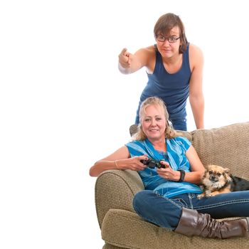 Worried teenage boy pointing out danger to his mom while she plays his video game. The family pet Chihuahua watches with disinterest. Copy space on pure white background.