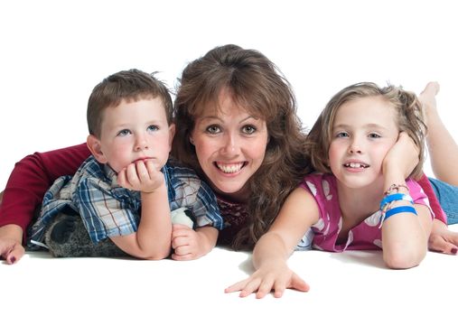 Young mother with her preschool son and daughter playing on the floor together. Isolated on a white background.
