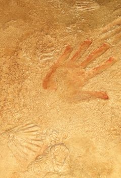 Red hand print on stone