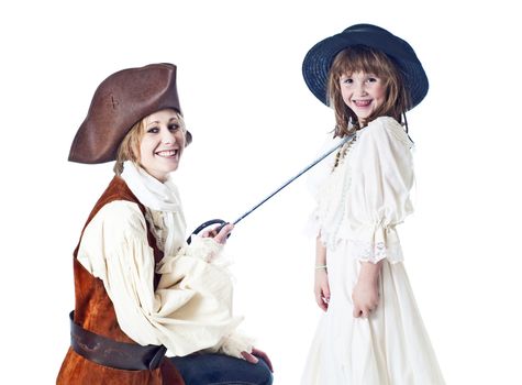 Cute little girl poses with her pretty aunt agaisnt a white background.