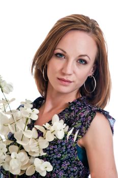 Pretty young woman posing for a headshot while holding white flowers.