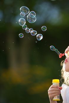 Air Bubbles blowing in the wind by kid