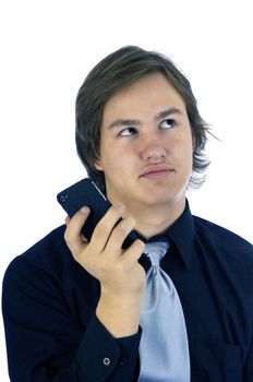 Young man rolling his eyes as a result of a text on his cellphone.