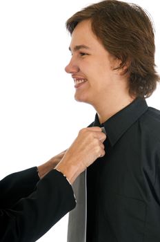 Mother helping her son to look good in a dress shirt and tie, adjusts his knot.